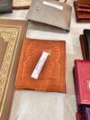 Small embossed leather purse, ochre color.