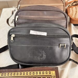 Black leather bag with several zipped pockets.