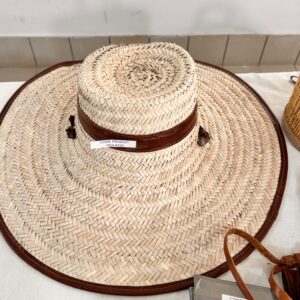 Large woven straw hat with leather band.