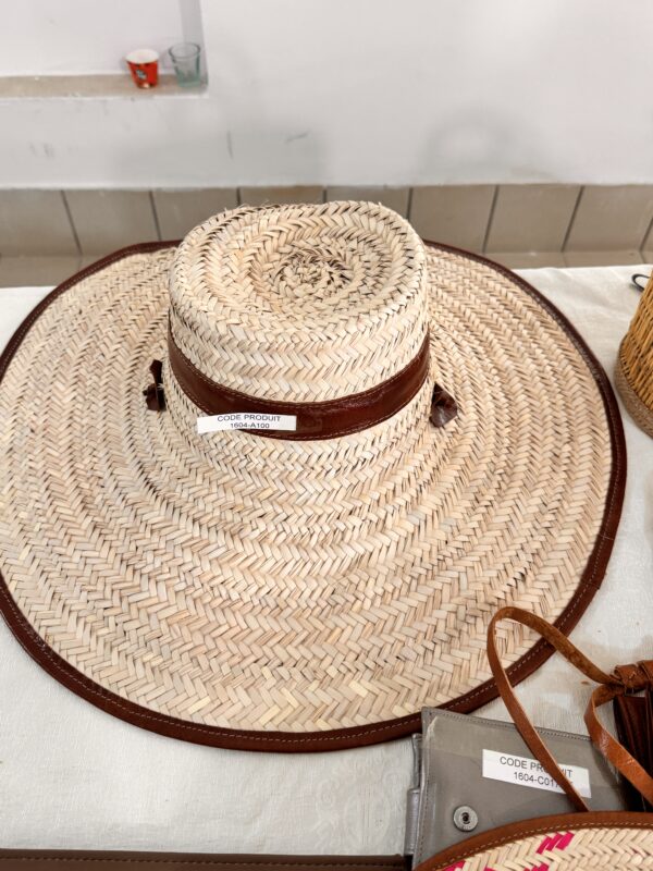 Large woven straw hat with leather band.