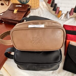 Beige leather bag with embossed geometric pattern.