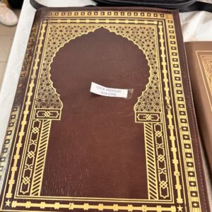 Rich gold decoration on brown leather, with architectural inspiration.