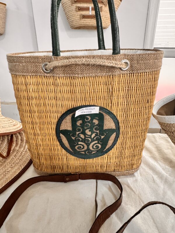 Straw bag with khomsa pattern cut into the burlap.